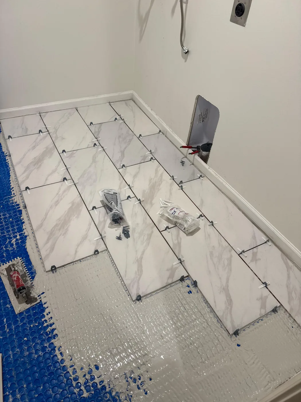 Tile floor installation with leveling clips in place